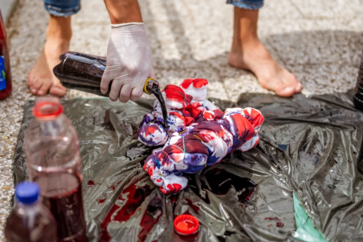 man making tie-dye shirt adult summer camp activity